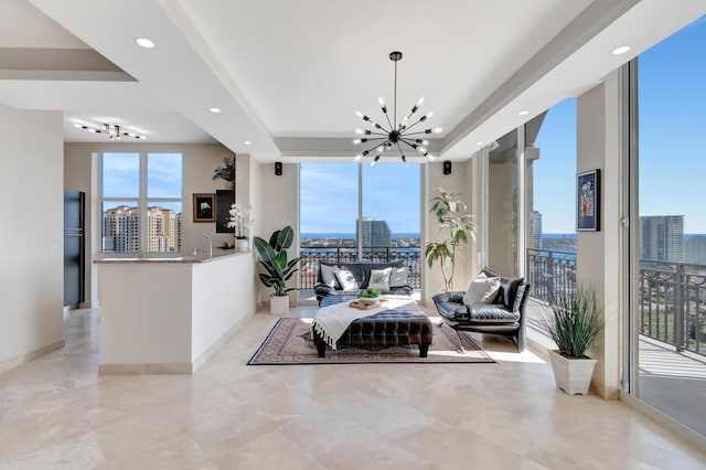 dining space featuring floor to ceiling windows and a notable chandelier