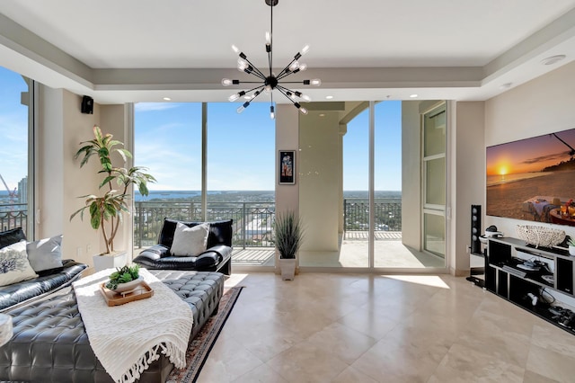 living room with floor to ceiling windows, a healthy amount of sunlight, and an inviting chandelier