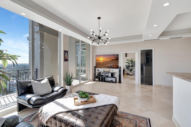 living room featuring a tray ceiling and a chandelier