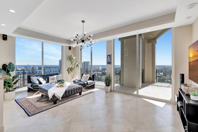 bedroom with access to exterior, a chandelier, multiple windows, and a wall of windows