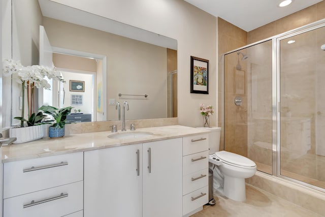 bathroom with vanity, toilet, and an enclosed shower