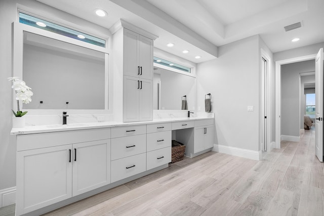 bathroom featuring hardwood / wood-style flooring and vanity