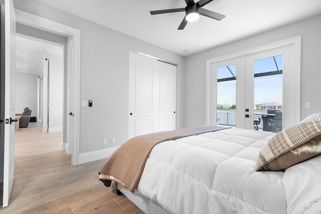 bedroom with french doors, light hardwood / wood-style flooring, access to outside, ceiling fan, and a closet