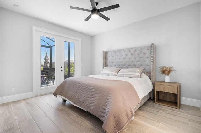 bedroom featuring ceiling fan, access to outside, light wood-type flooring, and french doors