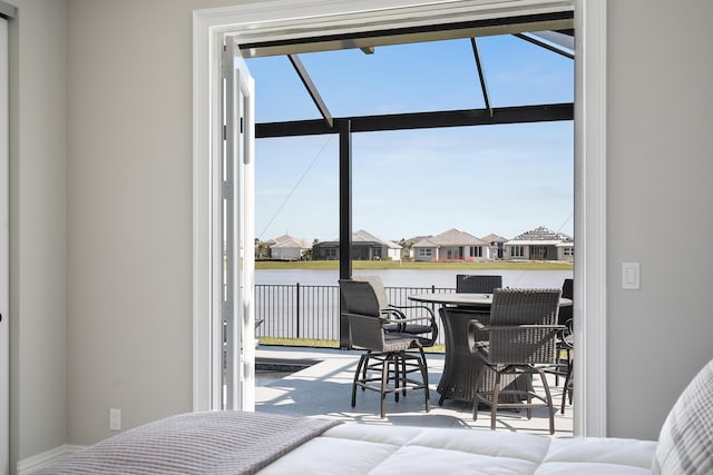 bedroom with a water view and multiple windows