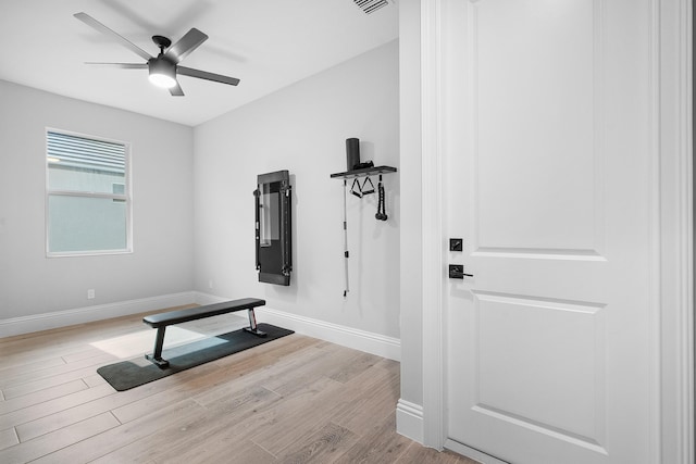 exercise area featuring ceiling fan and light wood-type flooring