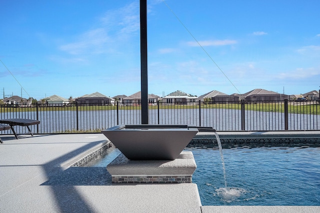 view of swimming pool with a water view