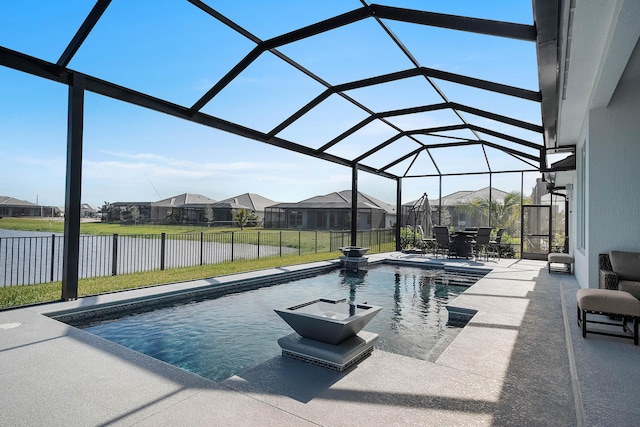 view of pool with a patio, a yard, and glass enclosure