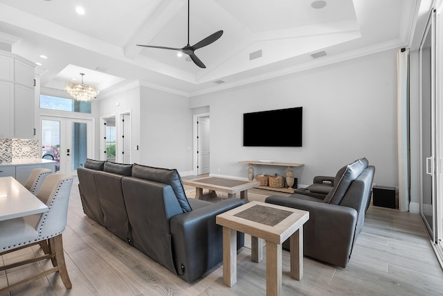 living room with french doors, ceiling fan with notable chandelier, light hardwood / wood-style flooring, and a high ceiling