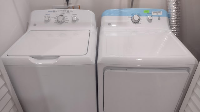 washroom with independent washer and dryer