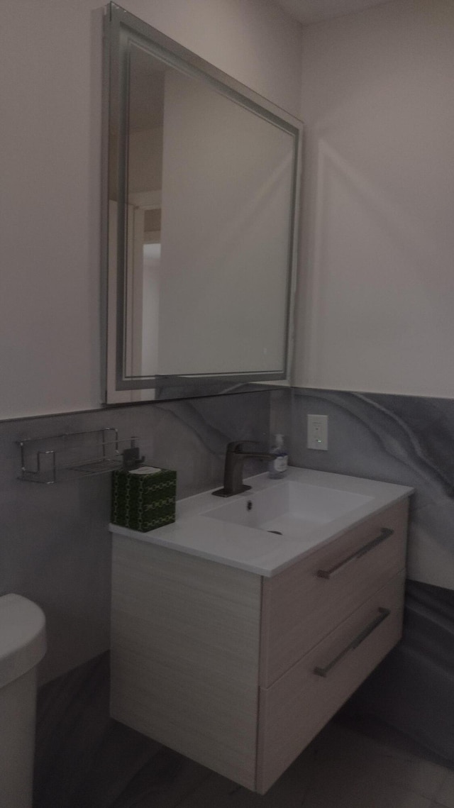 bathroom with vanity and toilet