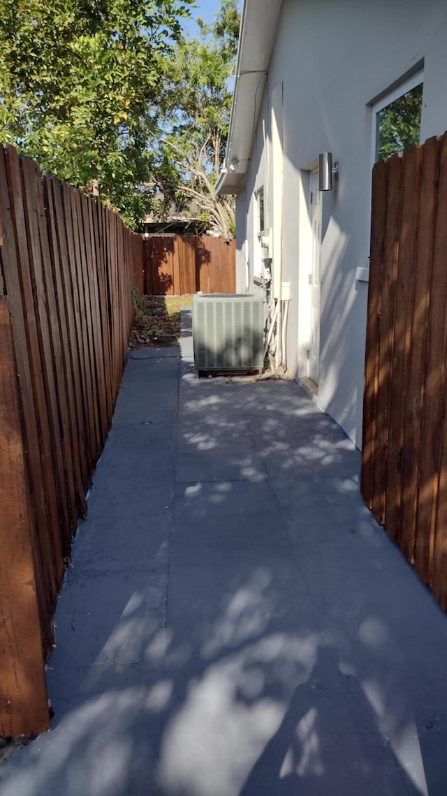 view of home's exterior featuring cooling unit and a patio