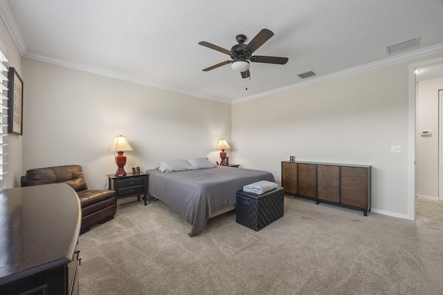 bedroom featuring ceiling fan, a textured ceiling, light carpet, and crown molding