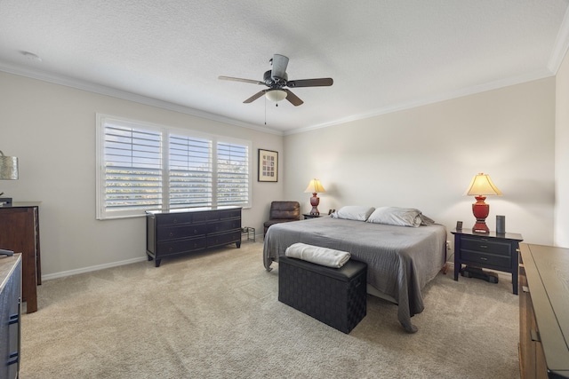 bedroom featuring ceiling fan, a textured ceiling, light carpet, and crown molding