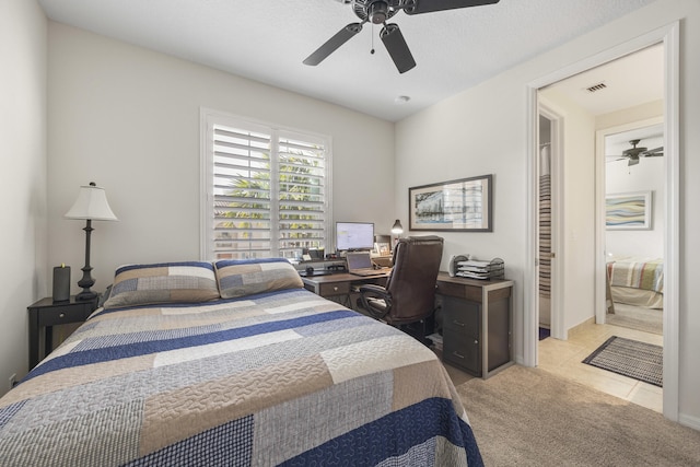 tiled bedroom featuring ceiling fan