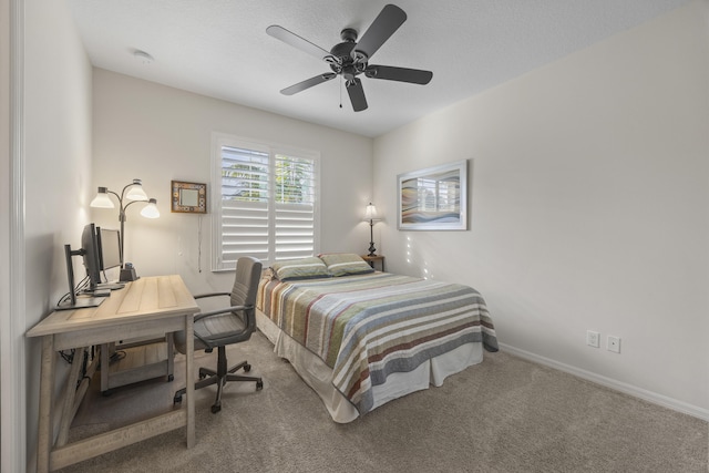 bedroom featuring a textured ceiling, ceiling fan, and carpet