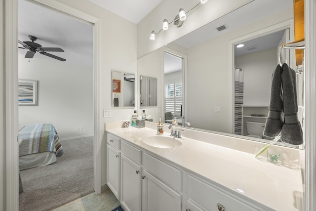 bathroom with ceiling fan, vanity, and toilet