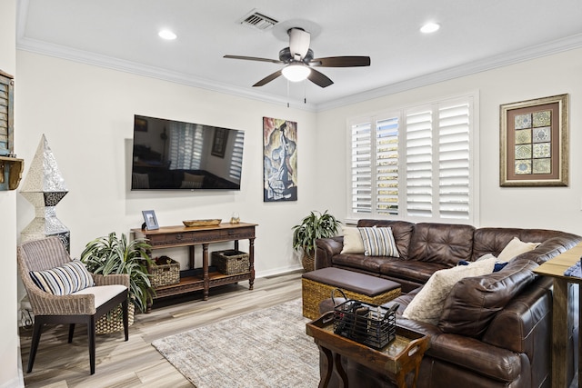 living room with light wood-type flooring, ceiling fan, and ornamental molding