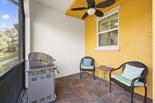 sunroom / solarium with ceiling fan and a healthy amount of sunlight