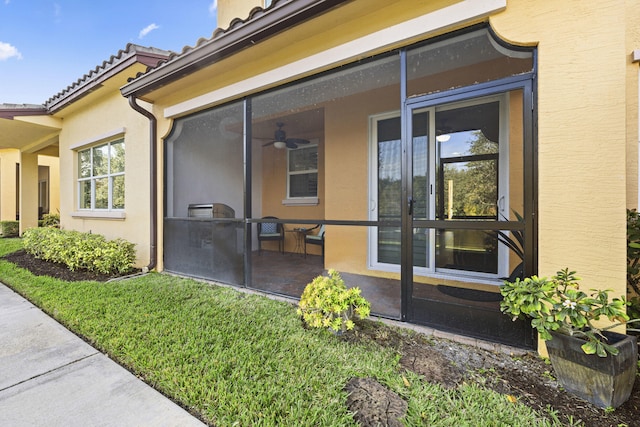 entrance to property with a lawn and a patio