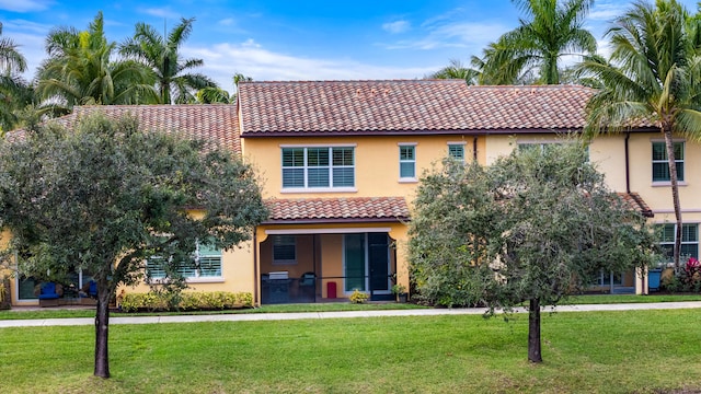 mediterranean / spanish home featuring a front lawn