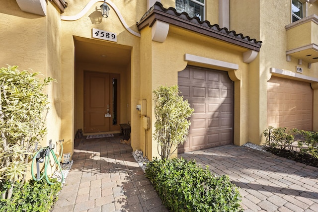 view of exterior entry with a garage