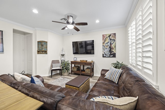 living room featuring ceiling fan, ornamental molding, and wood-type flooring