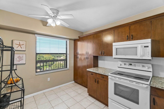 kitchen featuring decorative backsplash, light tile patterned floors, white appliances, and light stone countertops