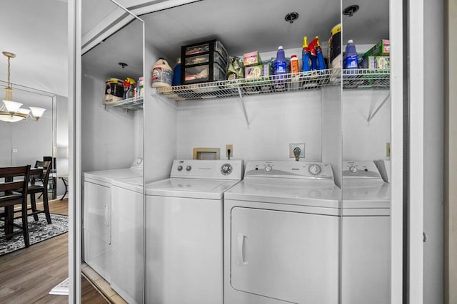 washroom with hardwood / wood-style floors and independent washer and dryer