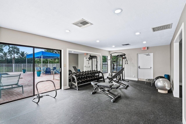 exercise room with a textured ceiling