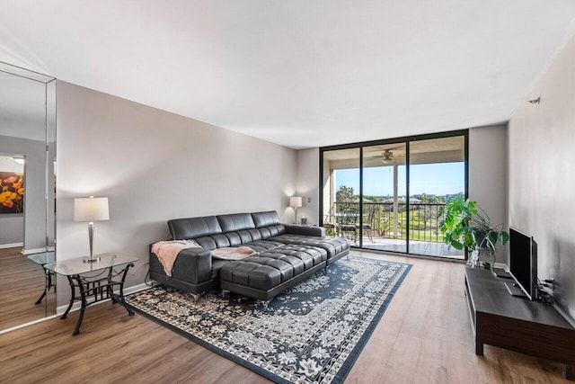 living room with hardwood / wood-style flooring and floor to ceiling windows