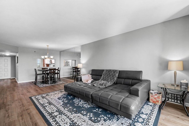 living room with hardwood / wood-style flooring and a notable chandelier