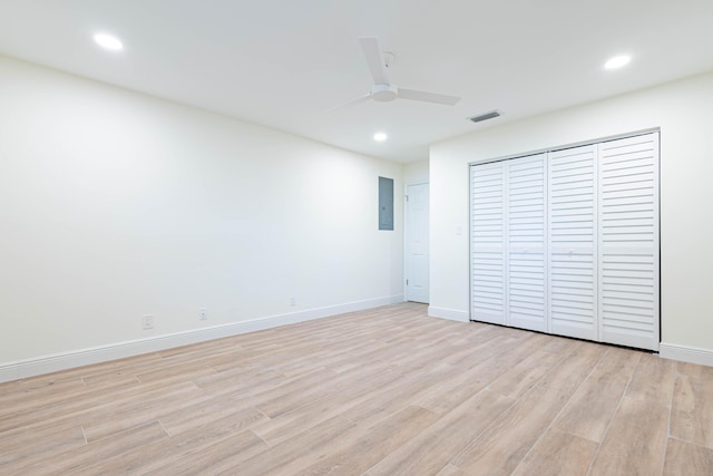 unfurnished bedroom featuring electric panel, ceiling fan, and light wood-type flooring