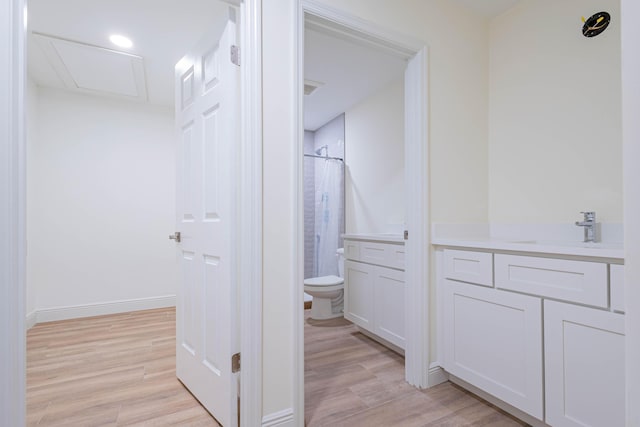 bathroom featuring walk in shower, vanity, wood-type flooring, and toilet