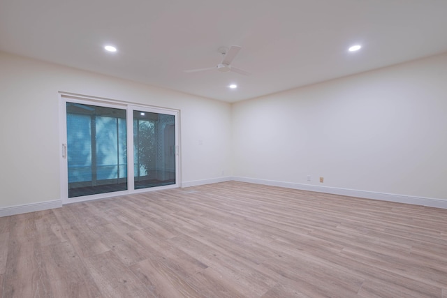 empty room with ceiling fan and light hardwood / wood-style flooring