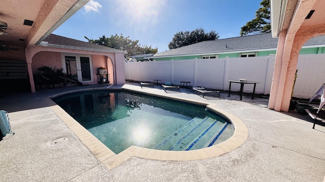 view of swimming pool featuring french doors and a patio