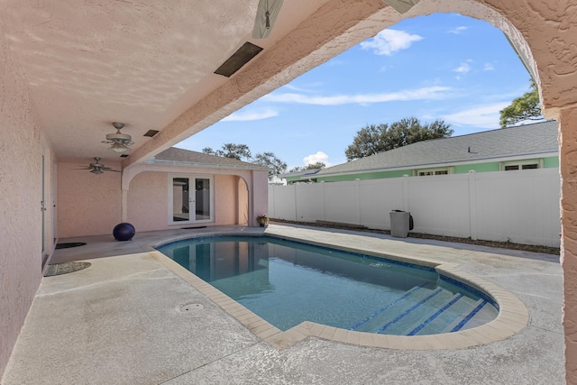 view of pool featuring french doors, ceiling fan, and a patio area