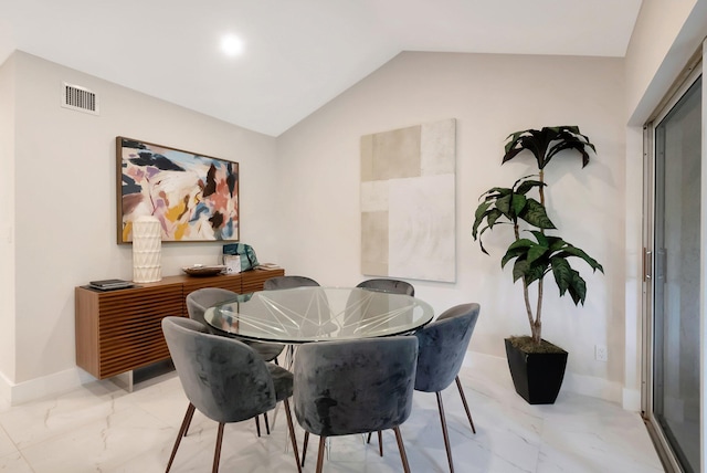 dining space featuring lofted ceiling