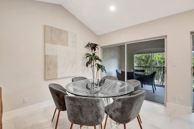 dining area featuring vaulted ceiling