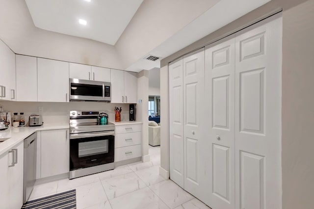 kitchen with appliances with stainless steel finishes and white cabinets