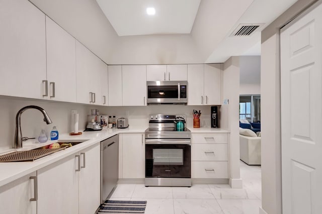 kitchen featuring stainless steel appliances, sink, and white cabinets