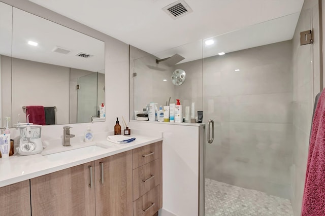 bathroom featuring vanity and an enclosed shower