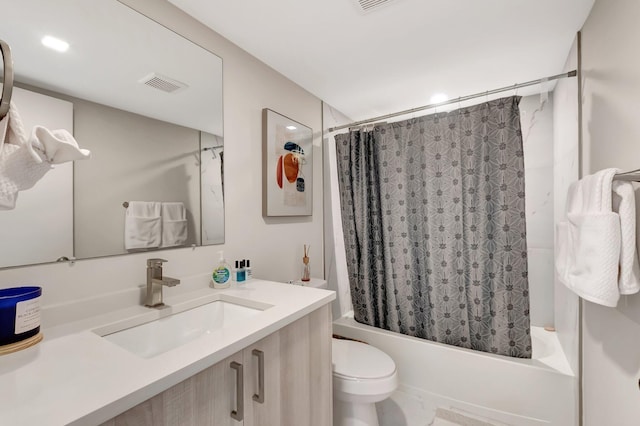 full bathroom featuring vanity, shower / bath combo, and toilet