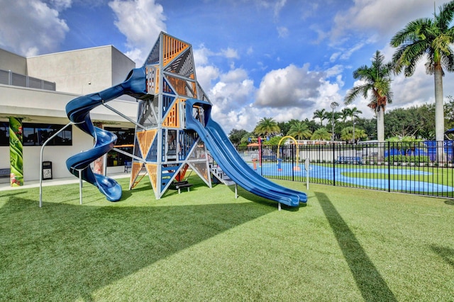 view of playground with a lawn