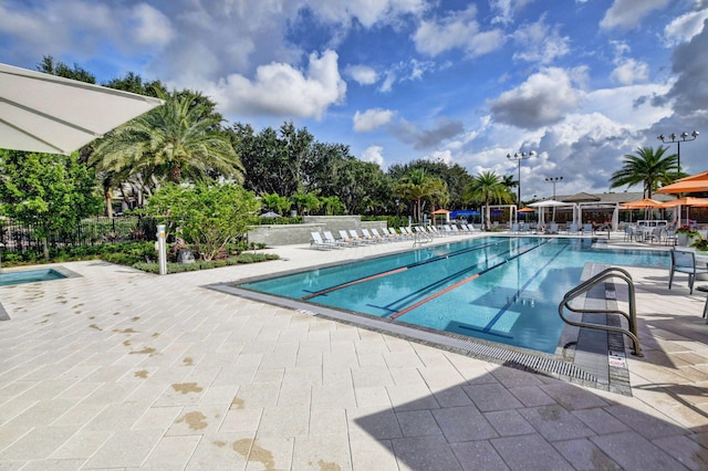 view of swimming pool featuring a patio area