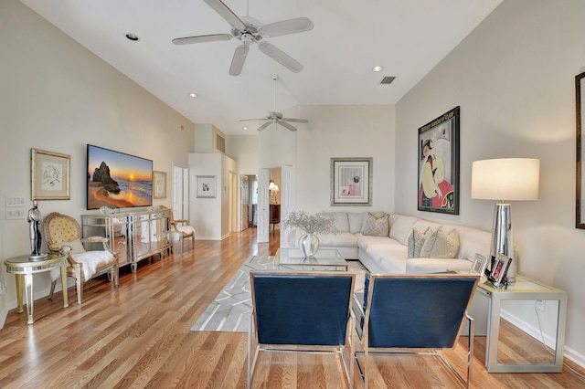 living room featuring ceiling fan and light hardwood / wood-style floors