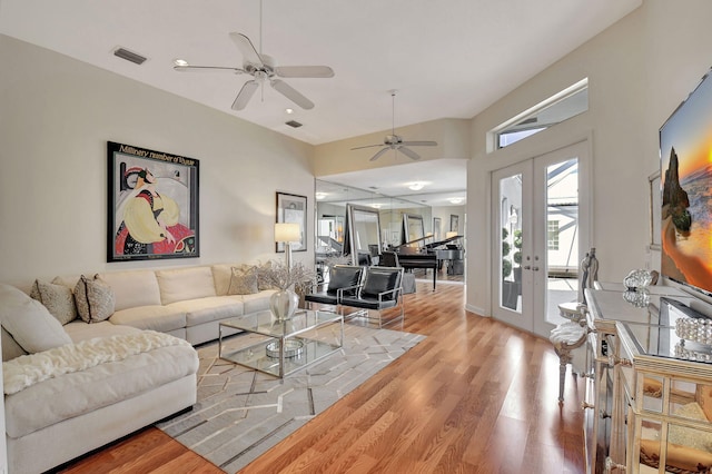 living room with ceiling fan, wood-type flooring, and french doors