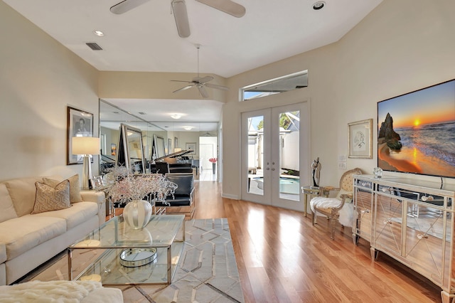 living room with ceiling fan, french doors, and light wood-type flooring