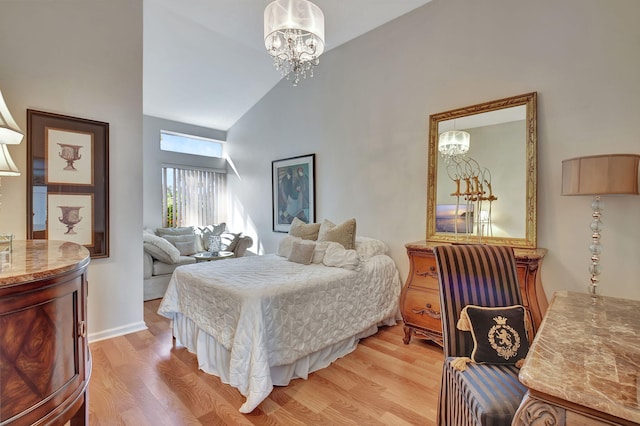 bedroom featuring vaulted ceiling, light hardwood / wood-style flooring, and a notable chandelier