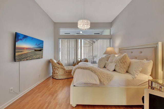 bedroom featuring hardwood / wood-style floors and an inviting chandelier